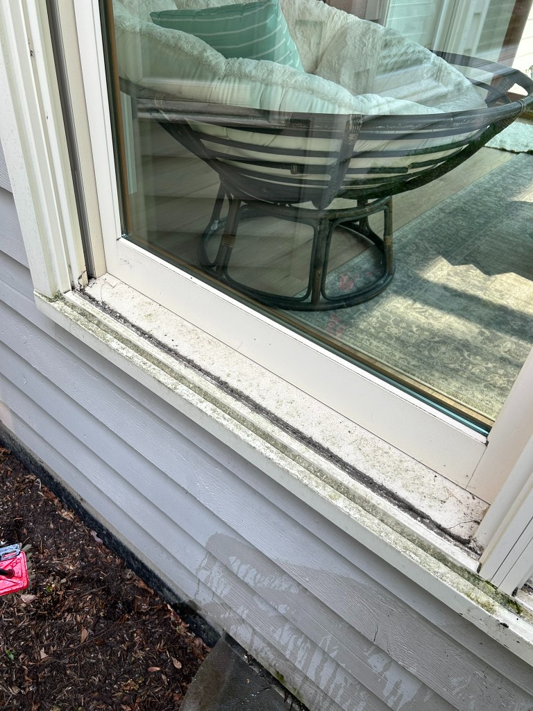 Window frame and sill with dirt and grime before cleaning